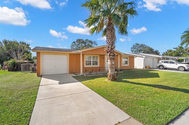 ranch-style home with covered porch, a garage, and a front yard