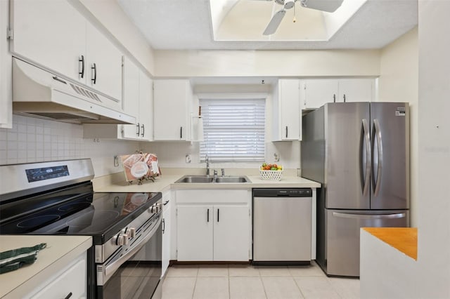 kitchen featuring sink, decorative backsplash, stainless steel appliances, and white cabinets