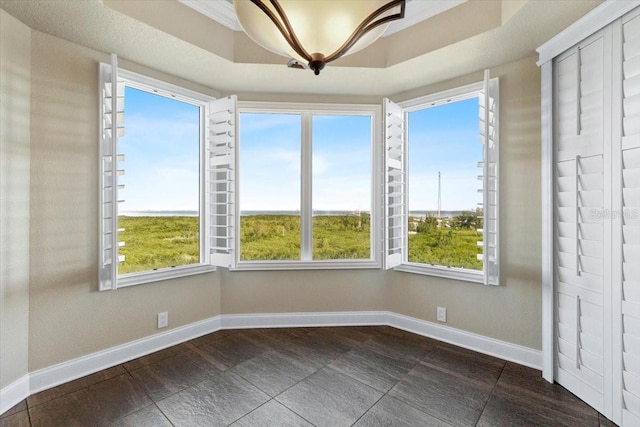 unfurnished sunroom with a tray ceiling