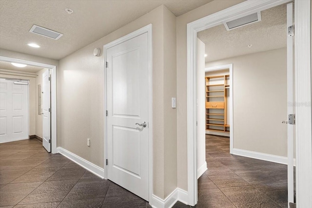 hallway featuring a textured ceiling