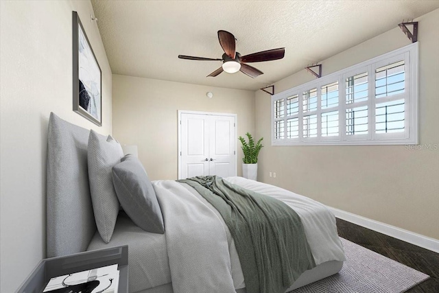 bedroom with ceiling fan, a closet, and a textured ceiling