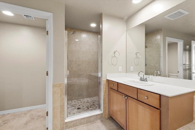 bathroom featuring vanity and a shower with shower door