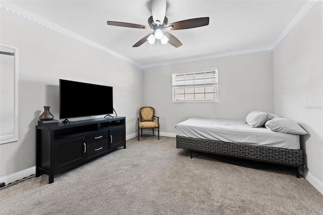 bedroom featuring ceiling fan, crown molding, and light carpet