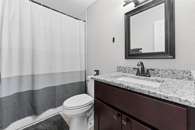 bathroom with vanity, a textured ceiling, toilet, and tile patterned flooring