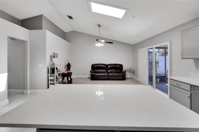 interior space with open floor plan, light countertops, vaulted ceiling, and a center island