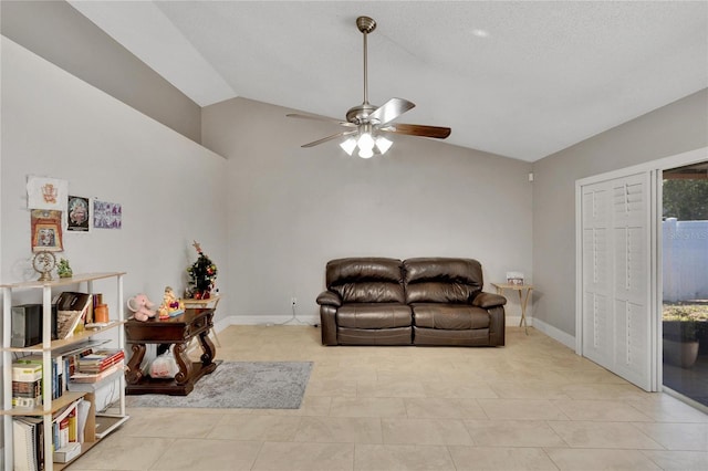 living room with lofted ceiling, light tile patterned floors, baseboards, and a ceiling fan