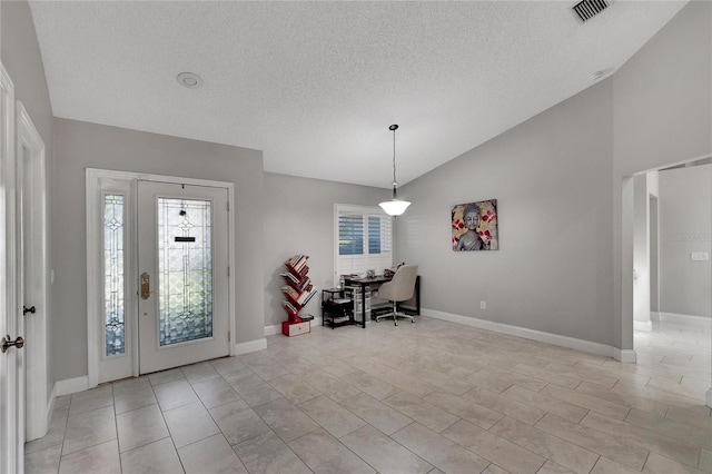 entrance foyer featuring vaulted ceiling, a textured ceiling, visible vents, and baseboards