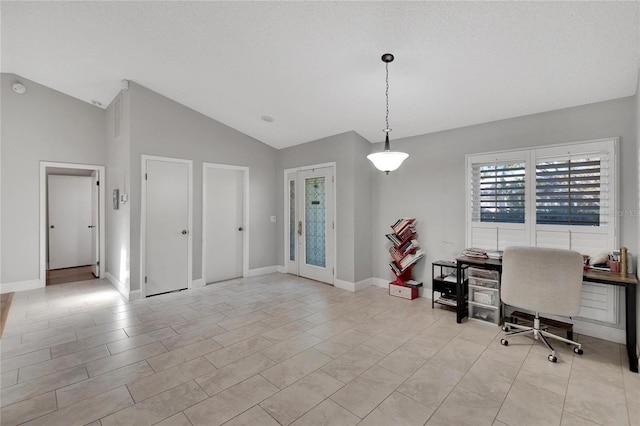 home office featuring vaulted ceiling, a textured ceiling, and baseboards