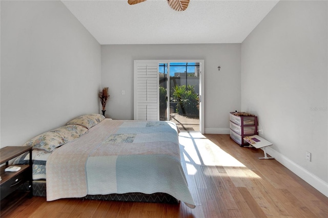 bedroom with ceiling fan, access to outside, light wood-type flooring, and baseboards