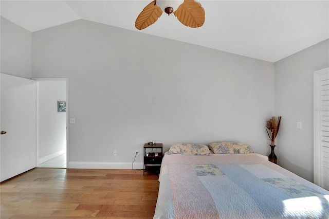 bedroom with lofted ceiling, wood finished floors, a ceiling fan, and baseboards