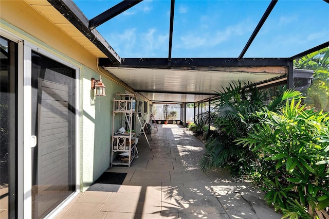 view of patio featuring a lanai