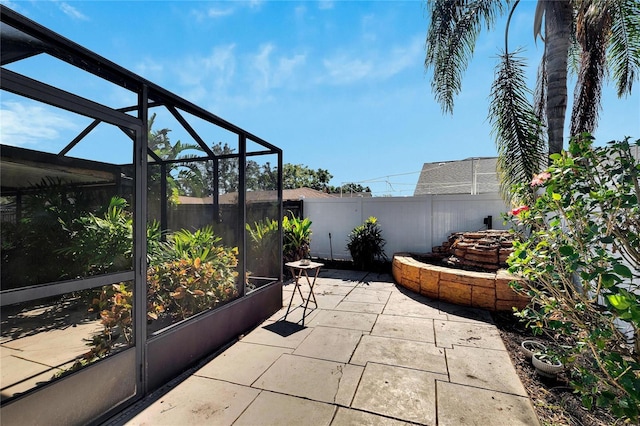 view of patio with a lanai and a fenced backyard