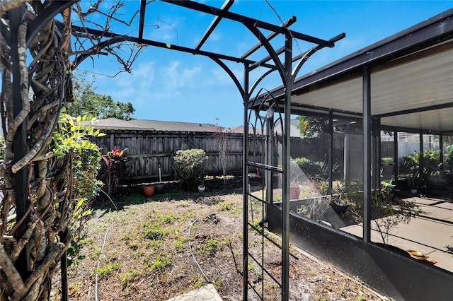 view of yard with a sunroom and a fenced backyard