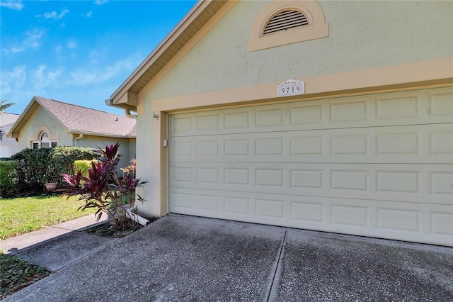 garage featuring concrete driveway