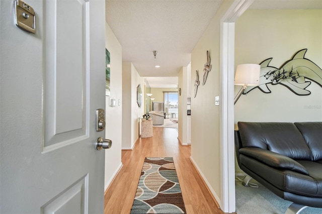 hallway with light hardwood / wood-style flooring