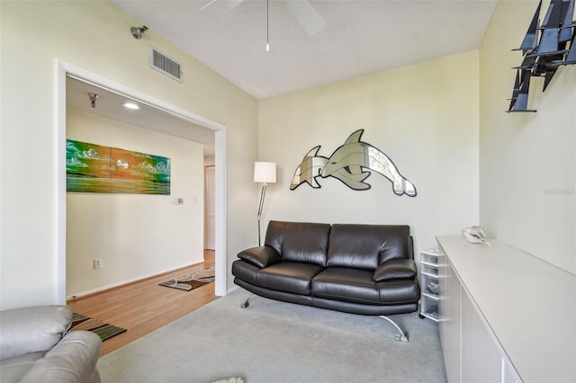 living room with ceiling fan and light wood-type flooring