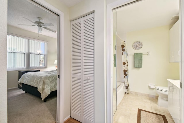 full bathroom featuring ceiling fan, shower / bath combo, tile patterned floors, toilet, and vanity