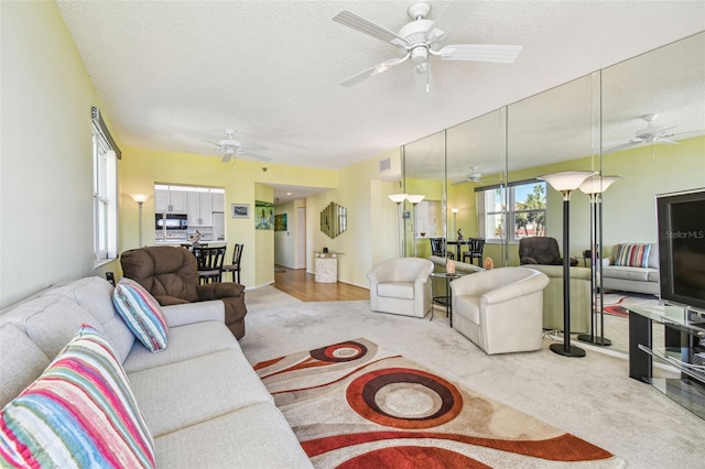 carpeted living room featuring a textured ceiling