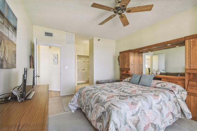 carpeted bedroom featuring ceiling fan, a textured ceiling, and connected bathroom