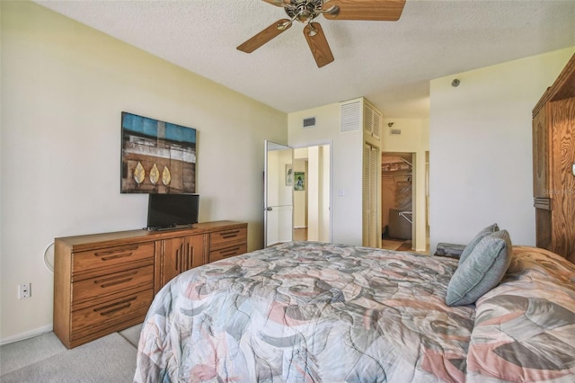 carpeted bedroom featuring ceiling fan, a closet, and a textured ceiling