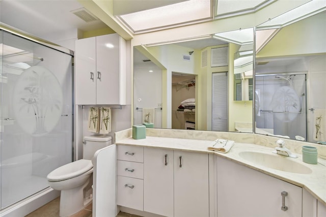 bathroom with vanity, toilet, and an enclosed shower