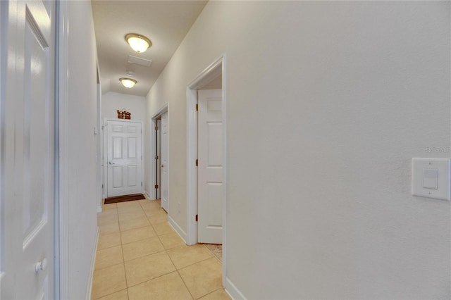 hall with light tile patterned floors