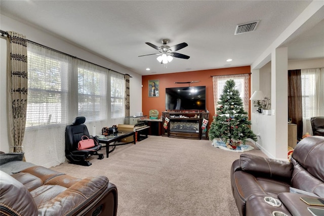 living room with carpet floors, a wealth of natural light, and ceiling fan