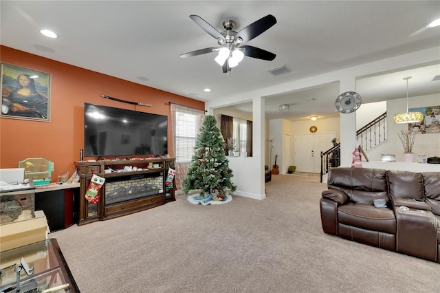 carpeted living room featuring ceiling fan