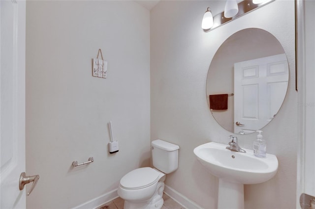 bathroom featuring tile patterned floors, toilet, and sink