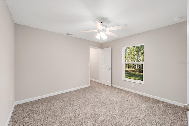 carpeted empty room with ceiling fan