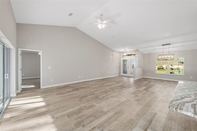 unfurnished living room featuring ceiling fan, french doors, light hardwood / wood-style floors, and lofted ceiling