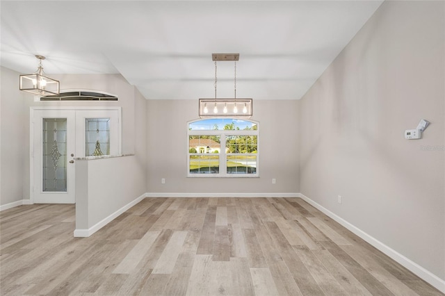 unfurnished dining area with light hardwood / wood-style floors and french doors