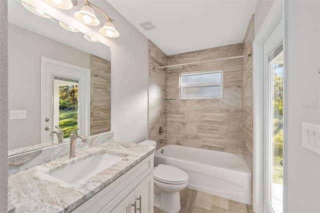 full bathroom featuring vanity, toilet, and tiled shower / bath