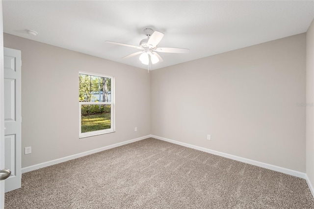 spare room with carpet and ceiling fan