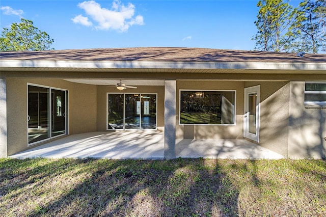 back of house with ceiling fan, a patio area, and a lawn