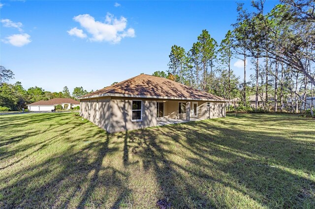 back of house featuring a lawn