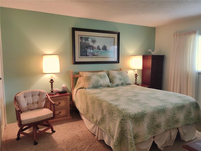 bedroom with a textured ceiling and light carpet