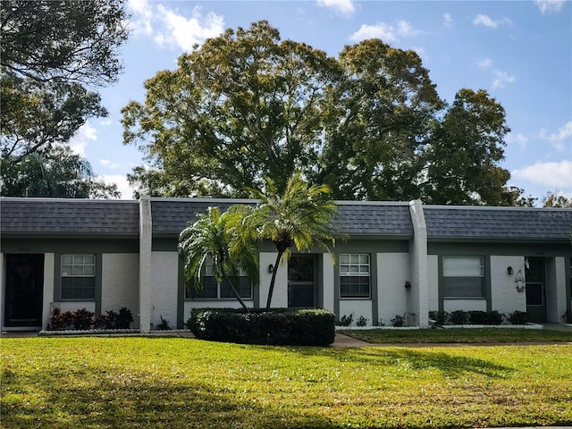 ranch-style home featuring a front yard