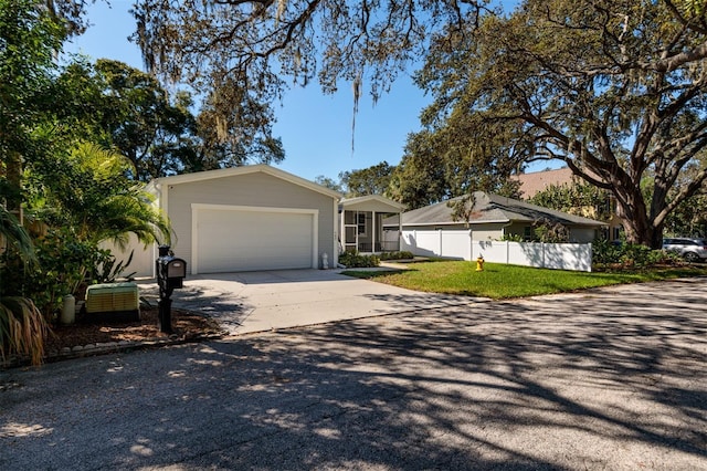 ranch-style house featuring a front yard and a garage