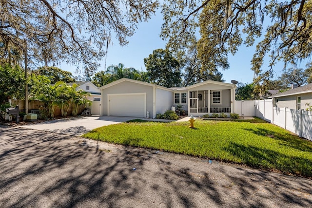 ranch-style house featuring a front lawn, a porch, and a garage