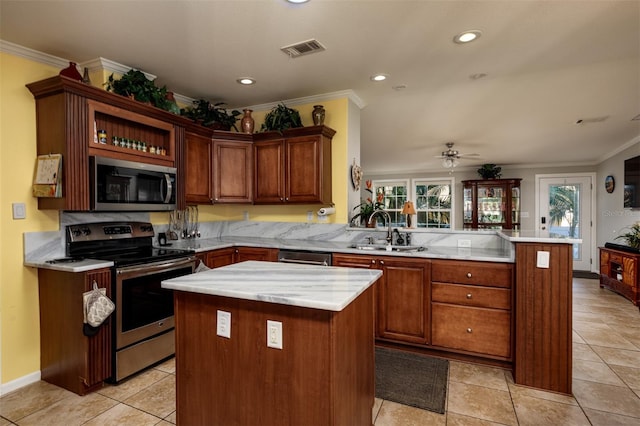 kitchen featuring a center island, crown molding, sink, kitchen peninsula, and stainless steel appliances