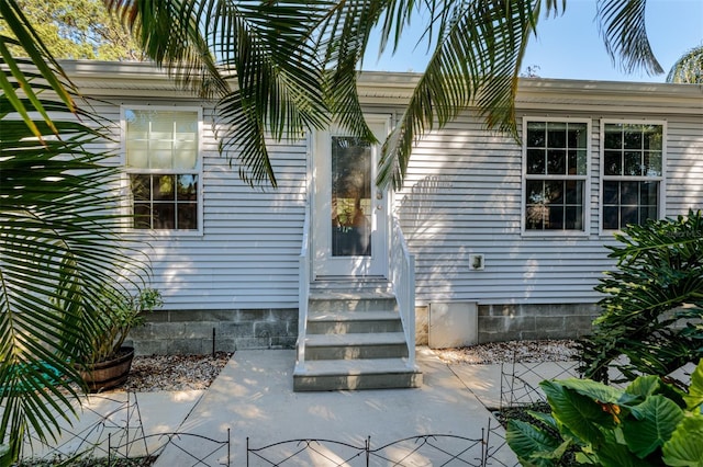 property entrance featuring a patio area