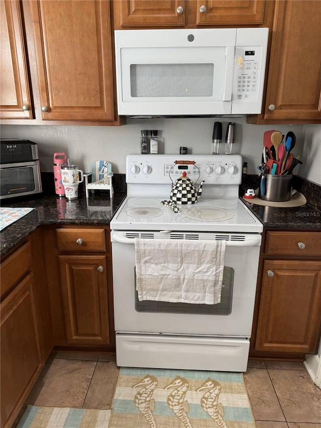 kitchen featuring white appliances and light tile patterned floors