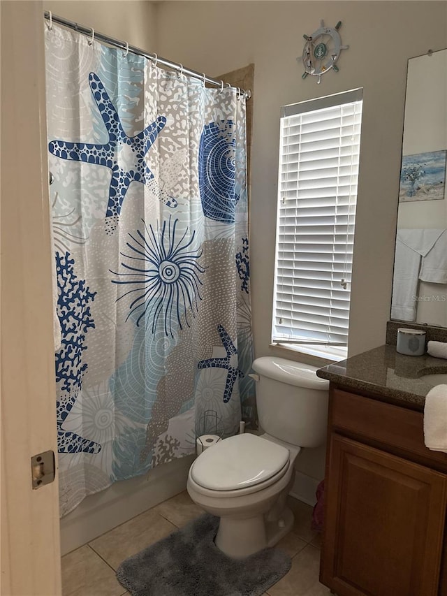 full bathroom with shower / bathtub combination with curtain, vanity, toilet, and tile patterned flooring