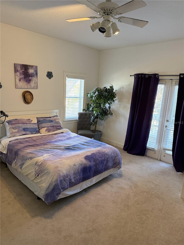 bedroom with carpet floors, access to outside, and ceiling fan