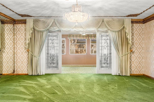 interior space featuring carpet, a textured ceiling, and an inviting chandelier