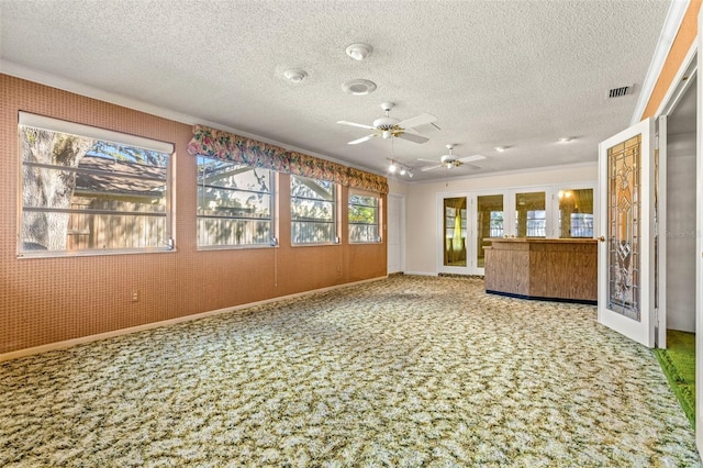 unfurnished sunroom featuring ceiling fan