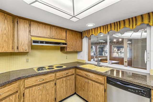 kitchen with decorative backsplash, sink, stainless steel dishwasher, and white stovetop