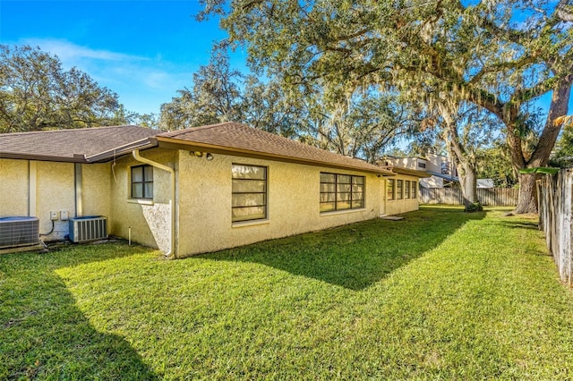 view of home's exterior featuring central AC unit and a yard