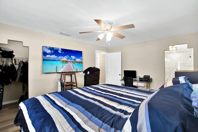 bedroom featuring hardwood / wood-style floors, ceiling fan, and a closet